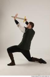 KEETA KNEELING POSE WITH SWORD